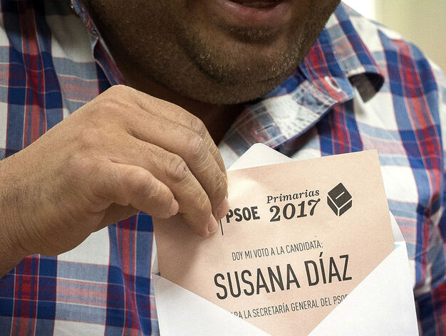 Un afiliado favorable a Susana D&iacute;az guarda su papeleta en el sobre antes de votar.