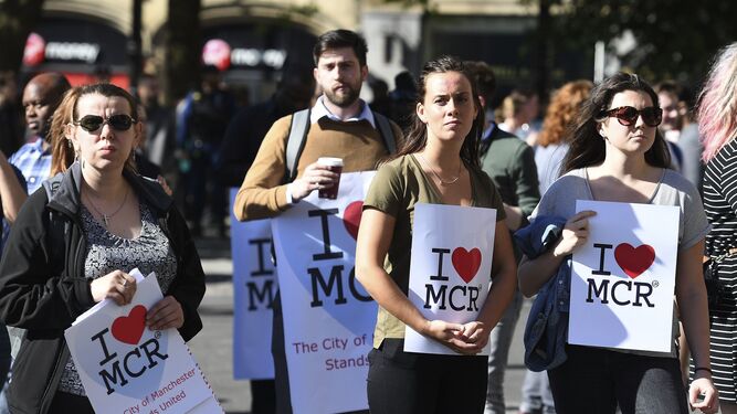Varias personas asistían ayer a una vigilia por las víctimas del atentado en Manchester.