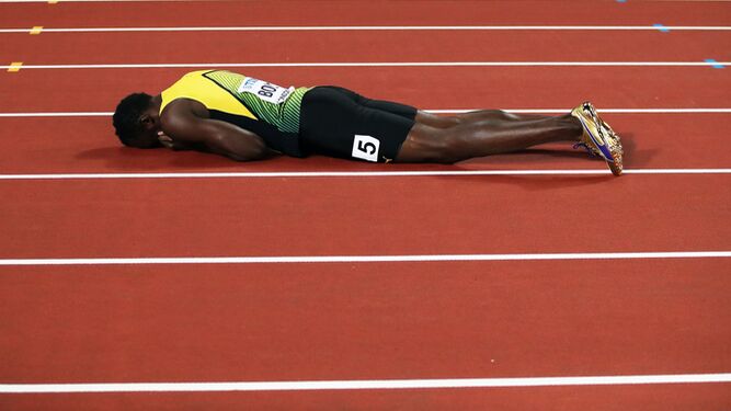 Usain Bolt, desolado tras terminar su carrera con una lesión.