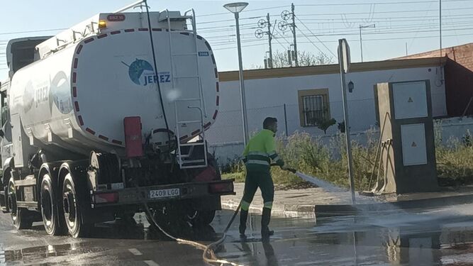 Un operario de la limpieza pública baldeando una calle de Jerez.